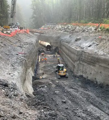 Laborers and equipment prepare a surface for concrete construction