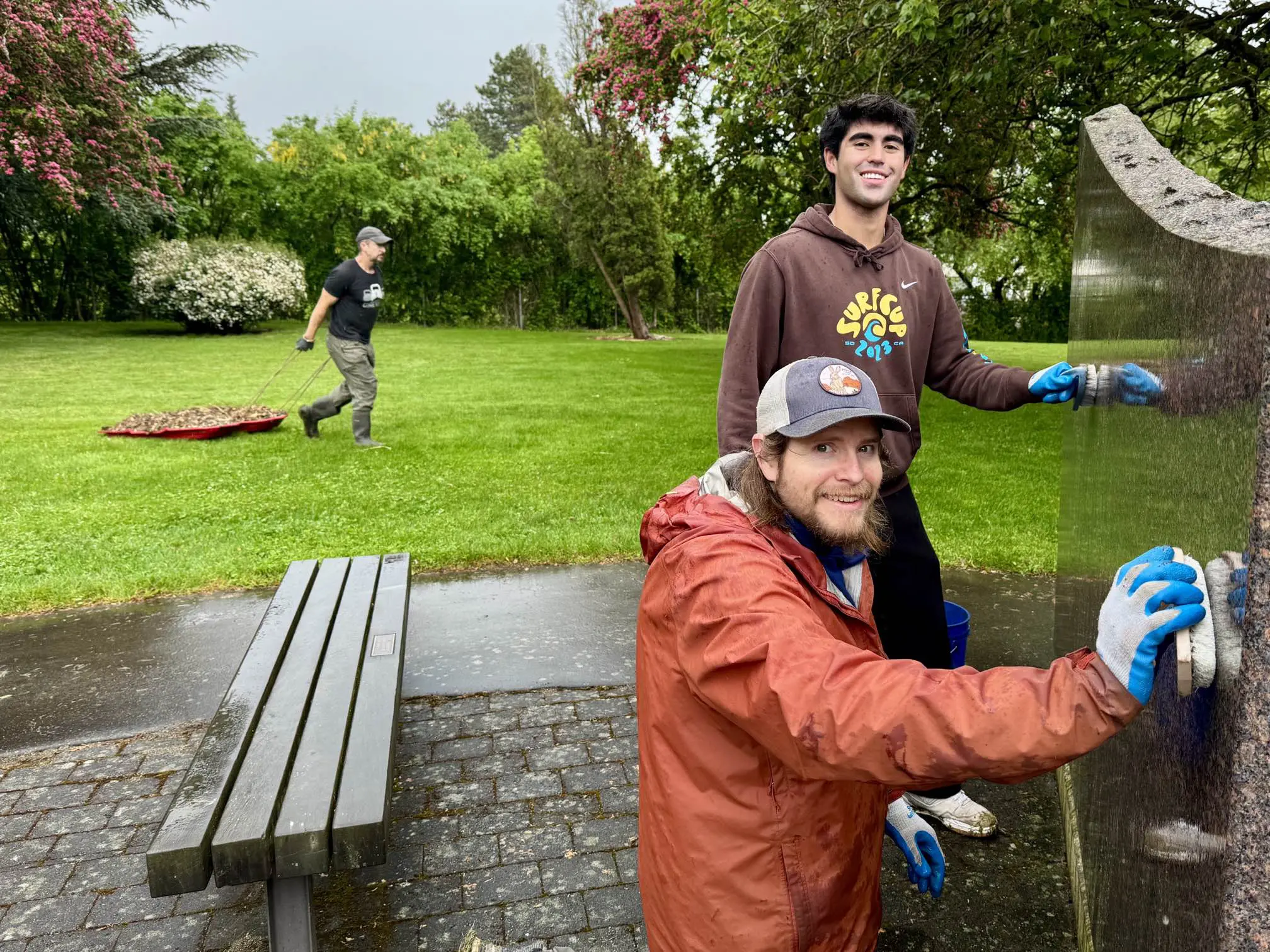 Two people clean a monument.