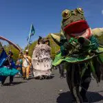A parade featuring large woodland costumes