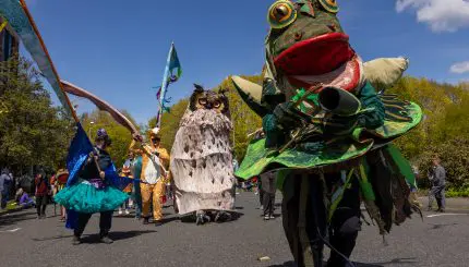 A parade featuring large woodland costumes