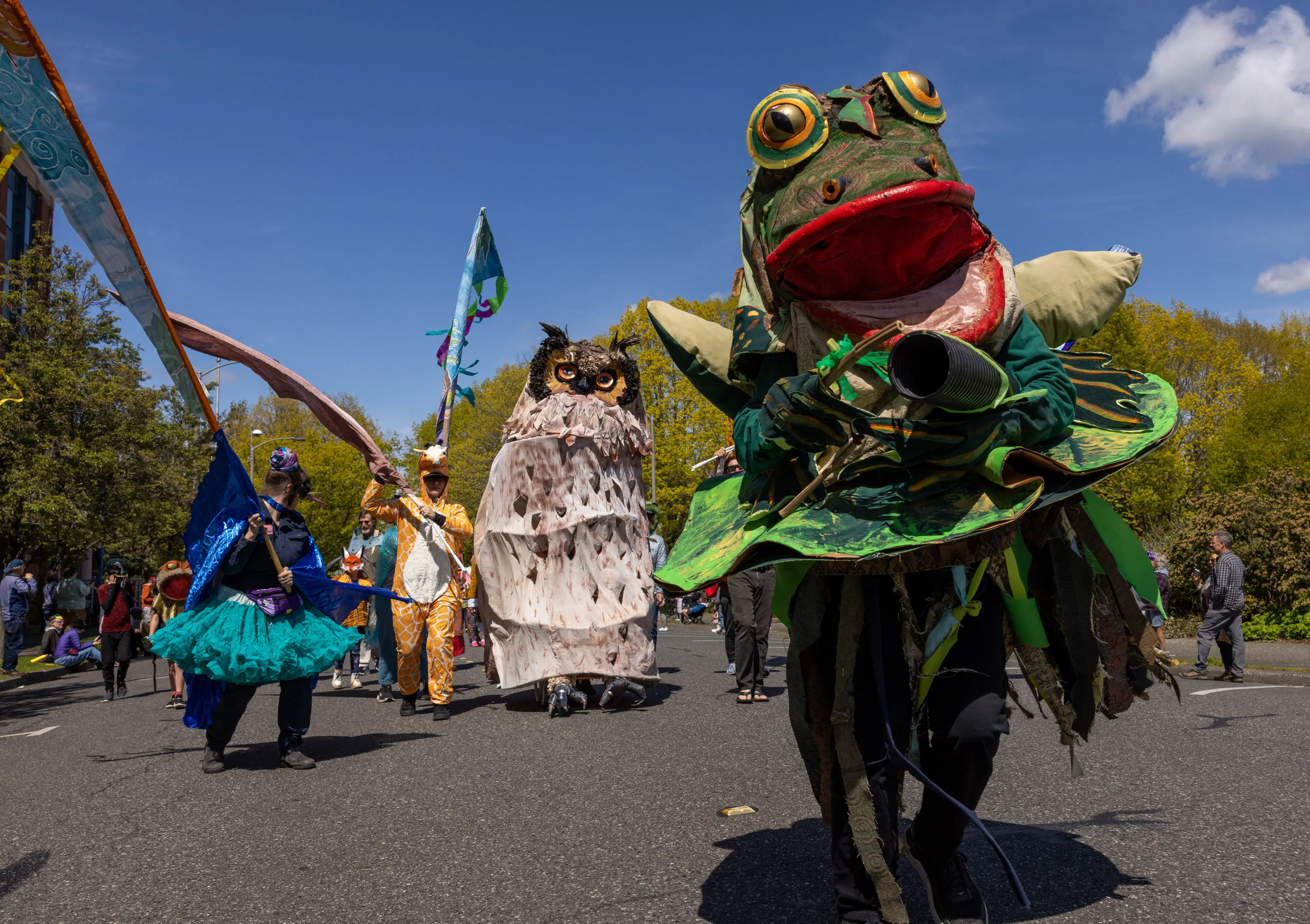 A parade featuring large woodland costumes
