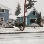 Residential street with snow on sidewalks and roads