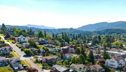Aerial view of houses in Fairhaven with mountains in the background.