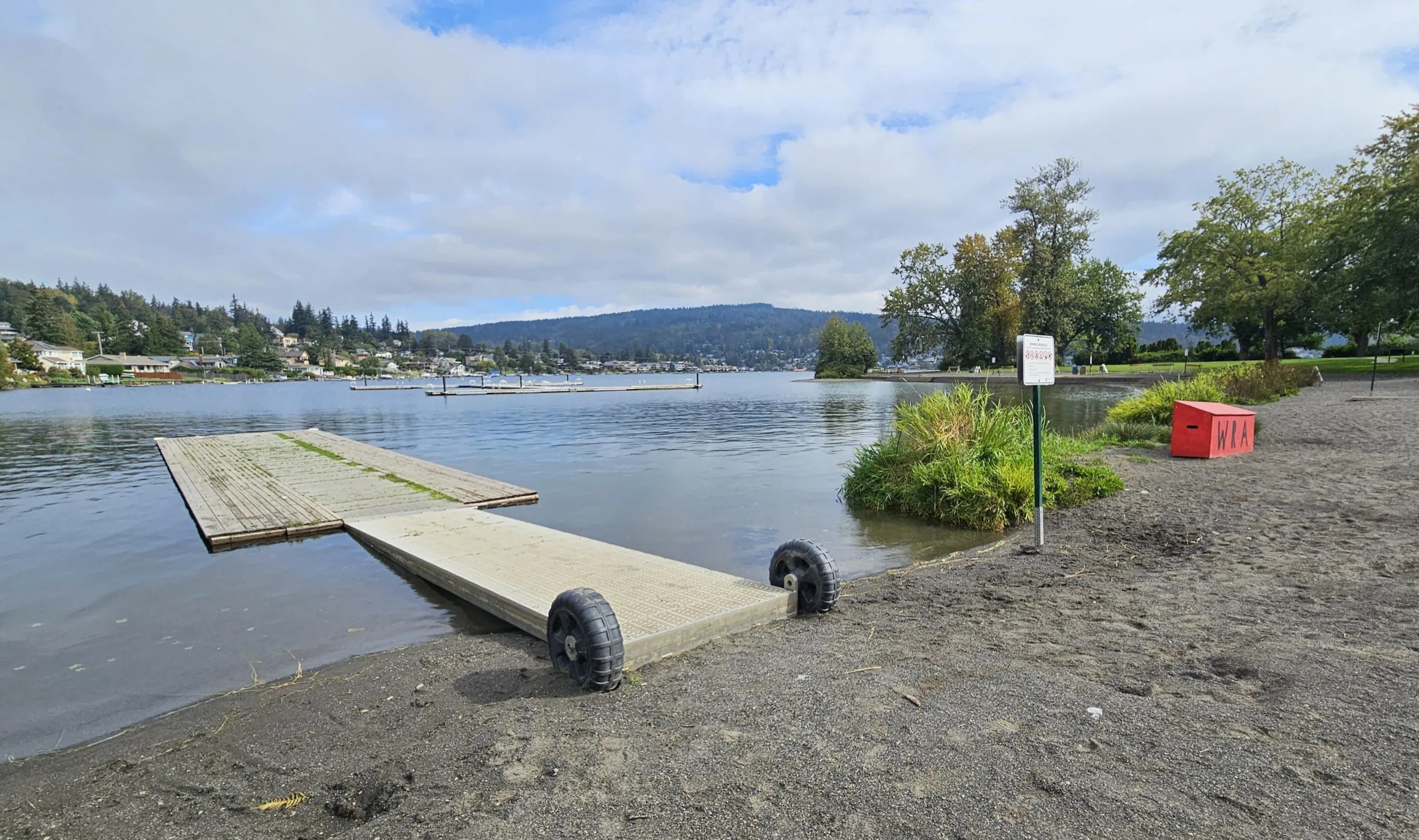 lakeside beach with wooden dock
