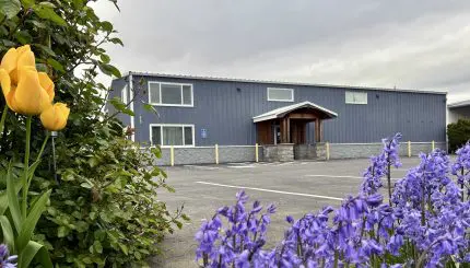 A building with flowers in front.