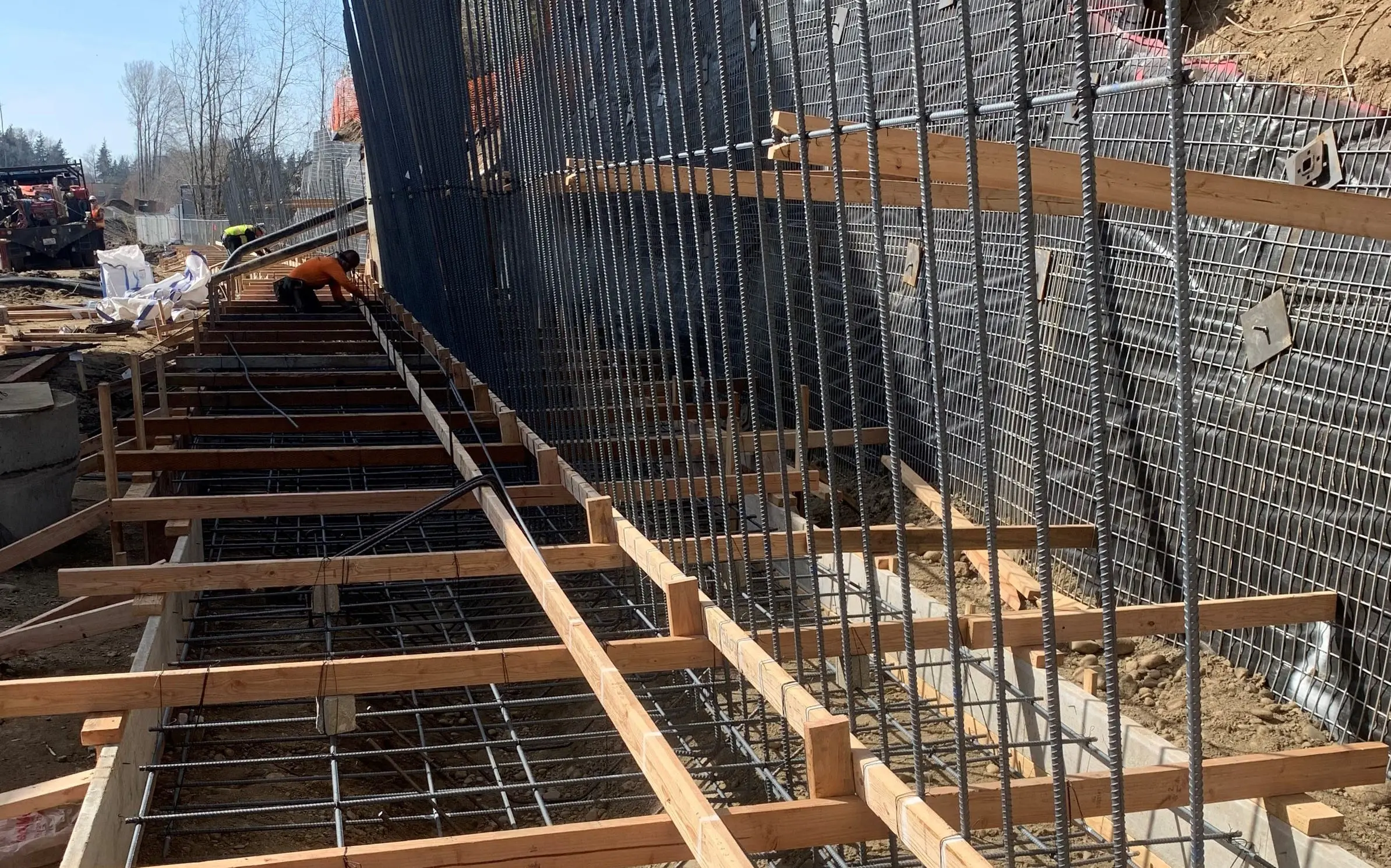 metal rebar and wood framing outdoors next to hill