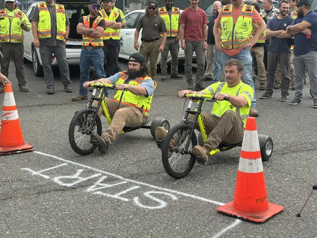 Two men line up at a start line on tricycles