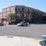 Photo of an intersection, facing in front of a brick building in Fairhaven.