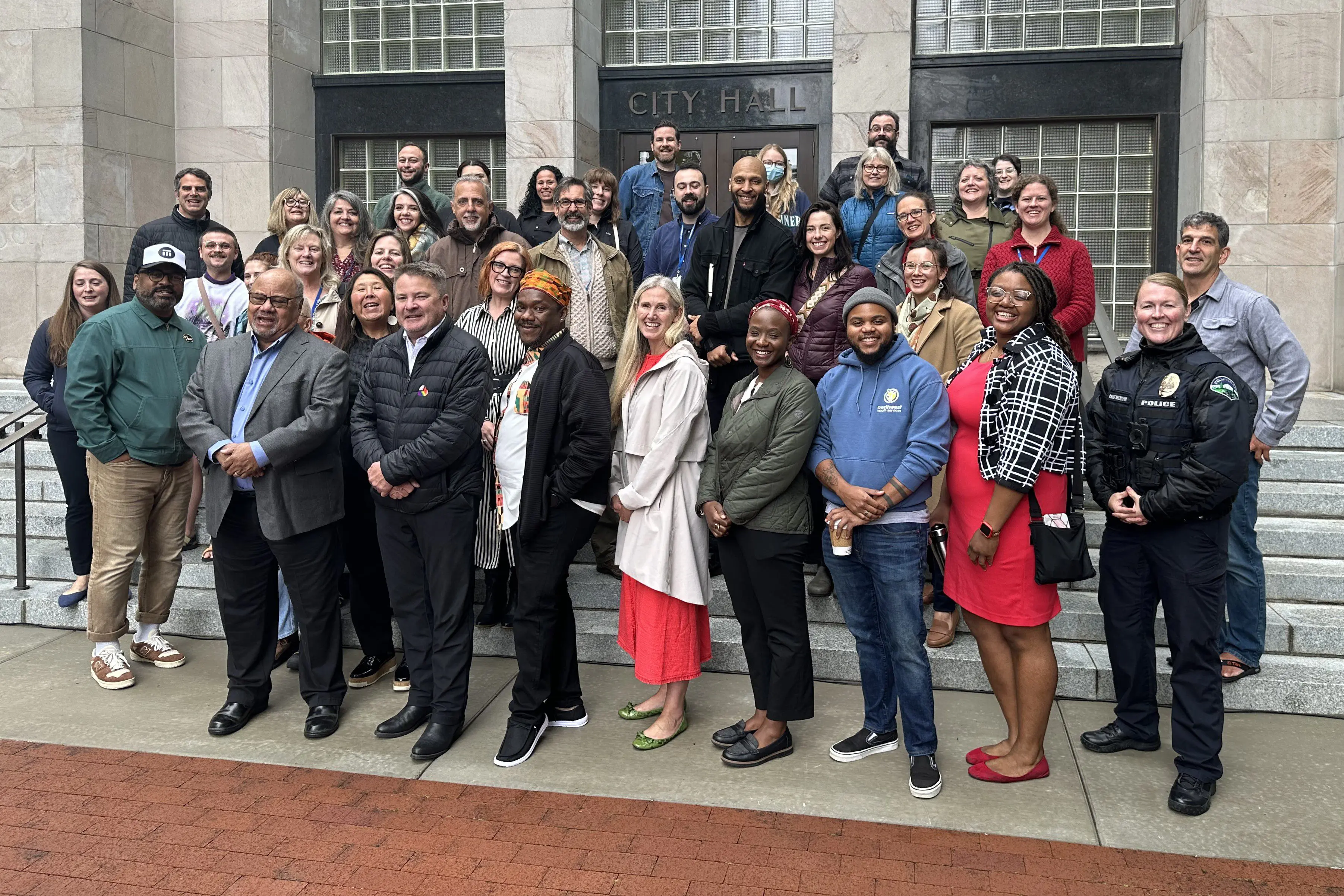 City and community leaders gather on the steps of City Hall for the 2024 Juneteenth flag-raising ceremony