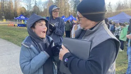 Adult and child in conversation standing in park-like setting