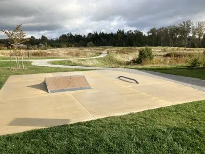 A small skateboarding ramp and grind rail