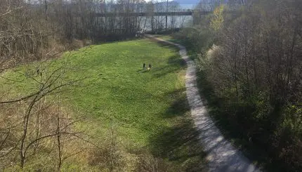 grassy field with gravel path on the right side