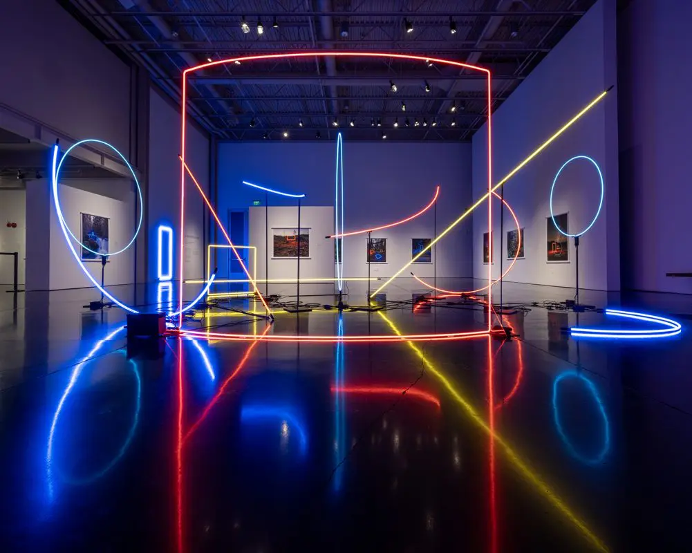A picture of a museum exhibit featuring neon shapes