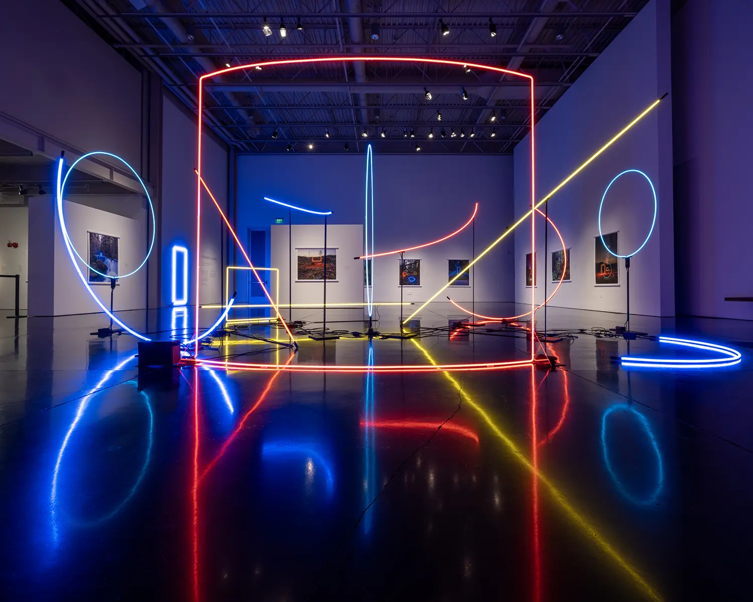 A picture of a museum exhibit featuring neon shapes