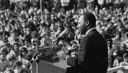 Martin Luther King delivering speech to crowd