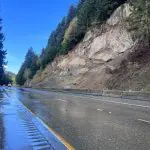 A freeway running next to a rocky slope