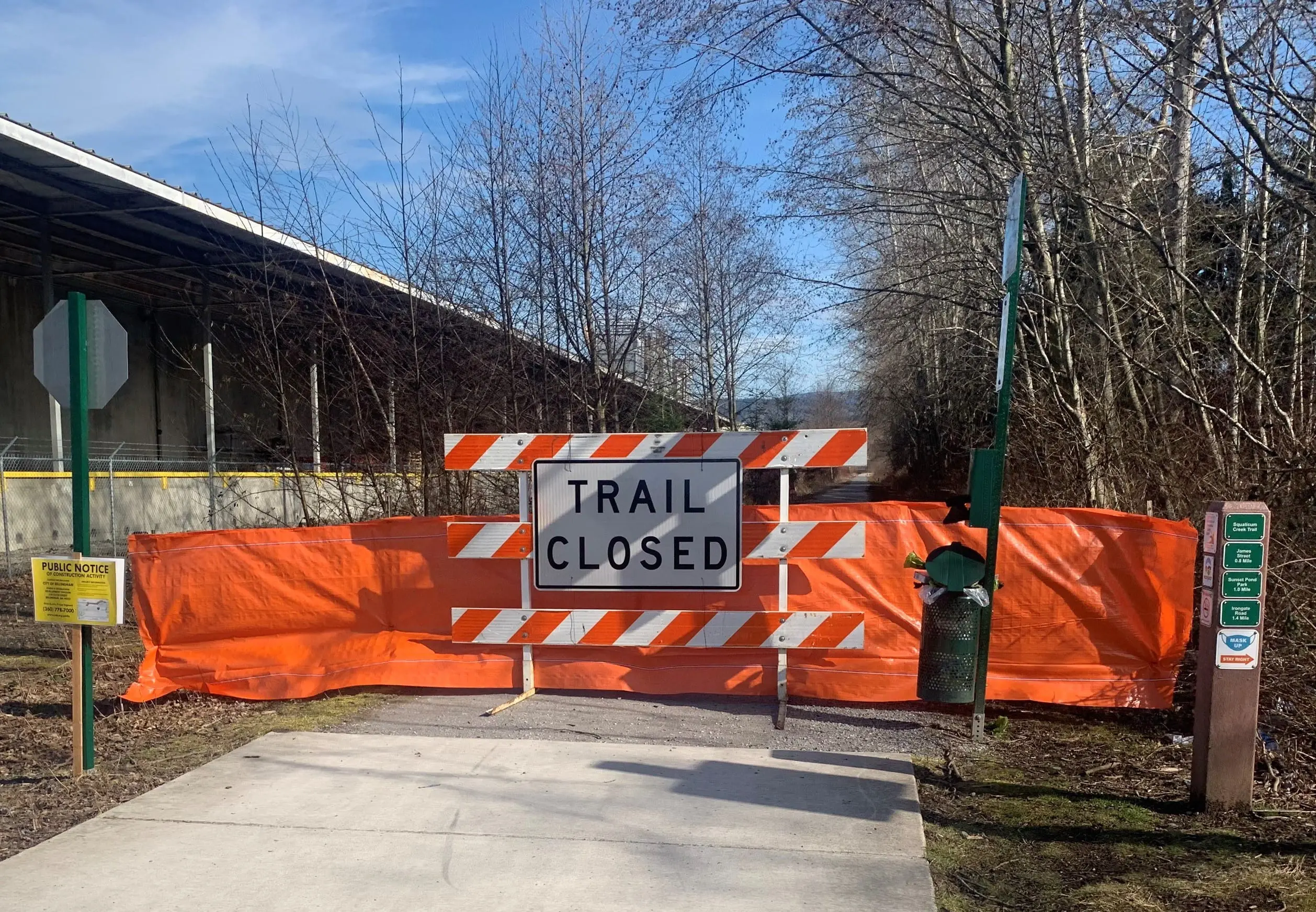 Trail closed sign with safety fence