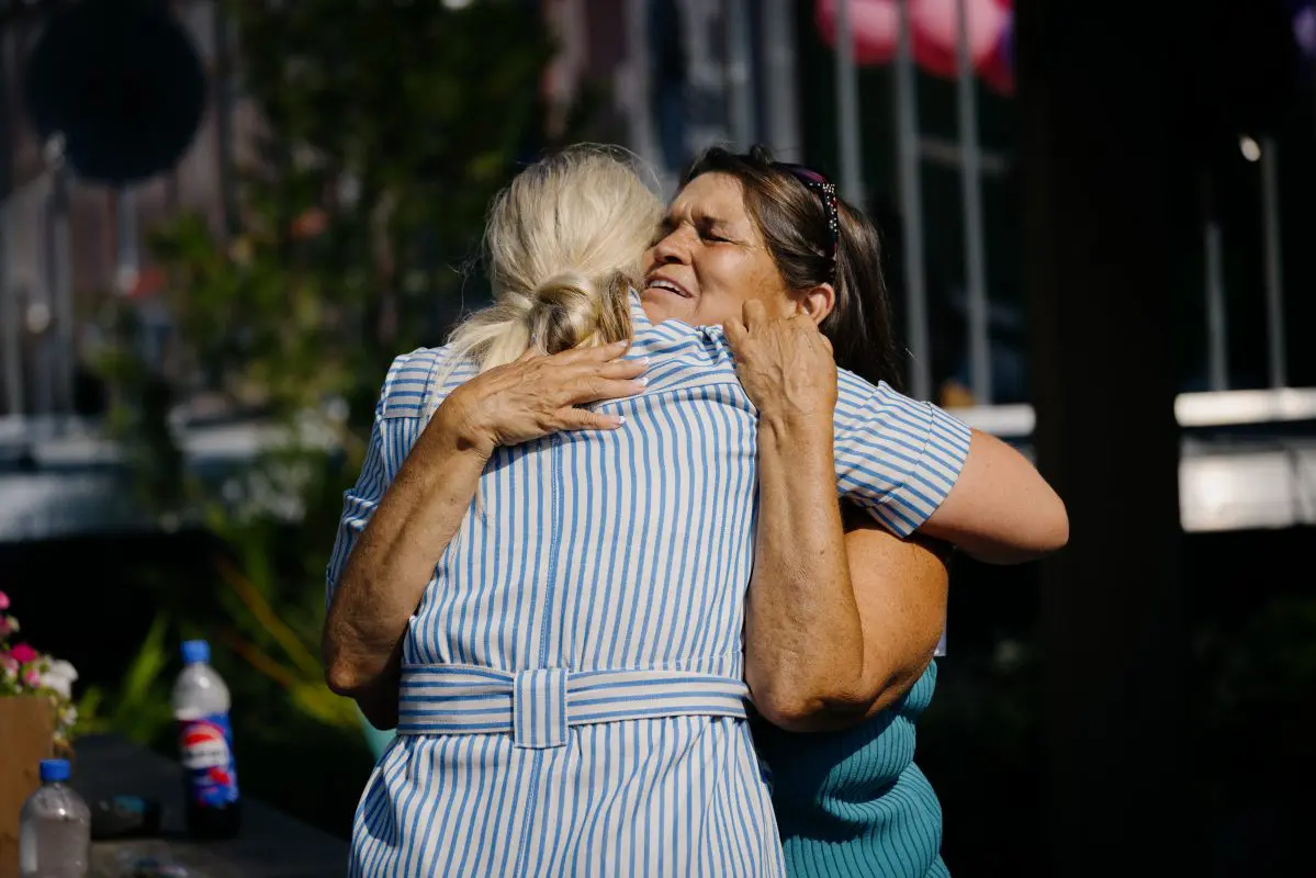 Two women hug