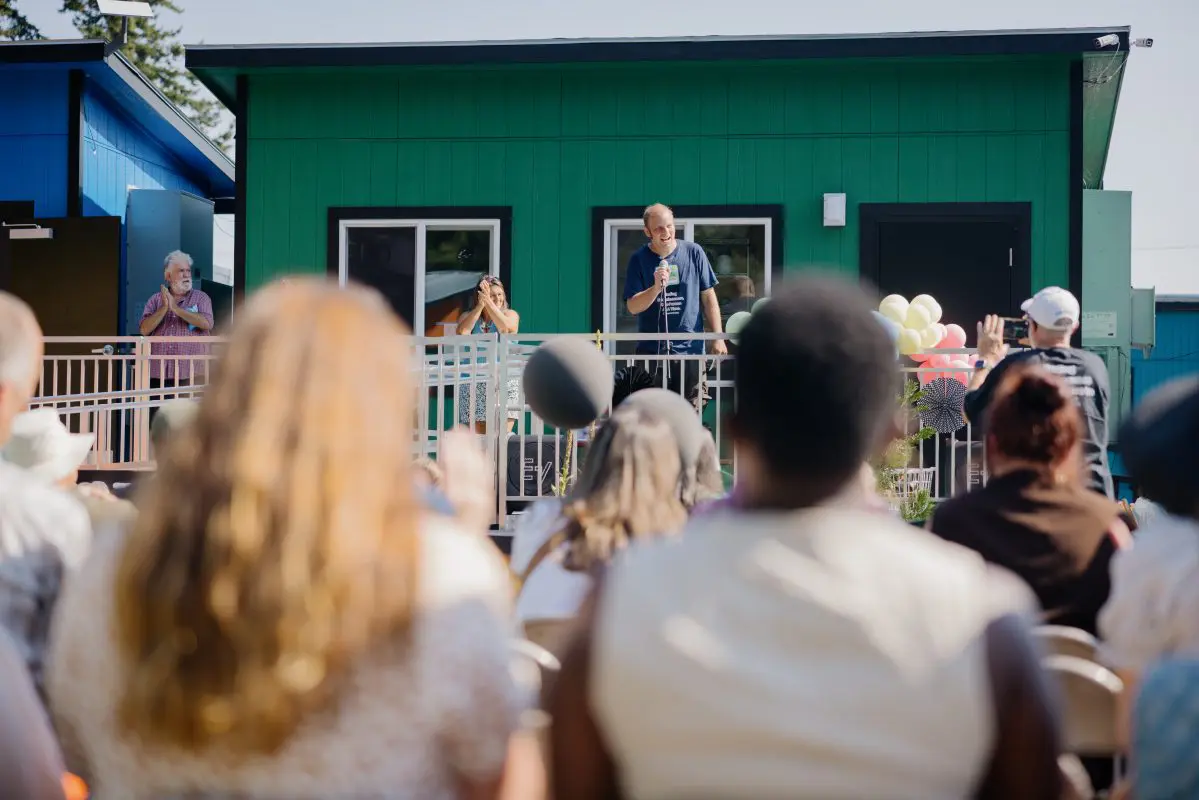 A man speaks from a platform
