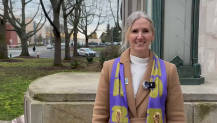 Mayor Kim Lund, wearing a Seattle FIFA World Cup scarf, is pictured on the steps oustide City Hall