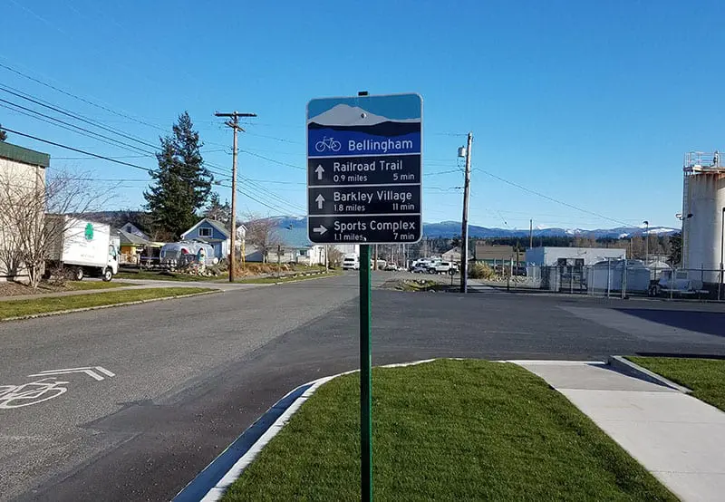 Sign with directions and mileage to help bicyclist navigate