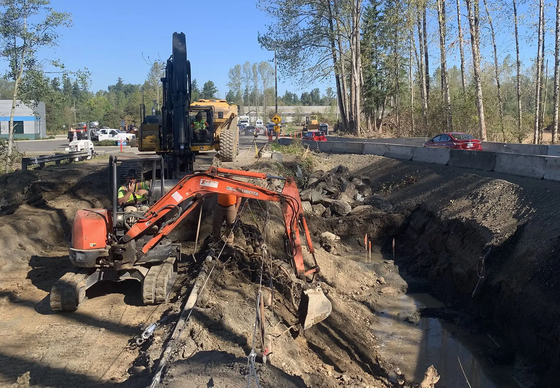 Excavator moving dirt to make new stream channel for Squalicum Creek near Squalicum Parkway.