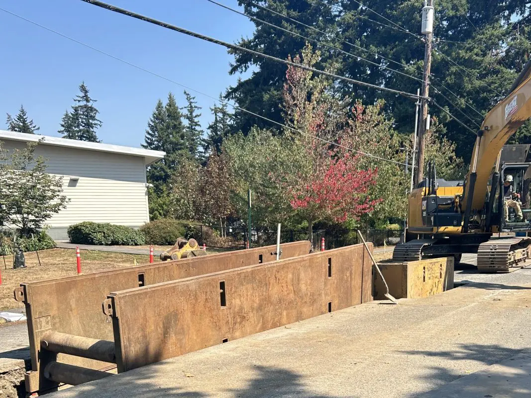 Large metal vault being placed under street