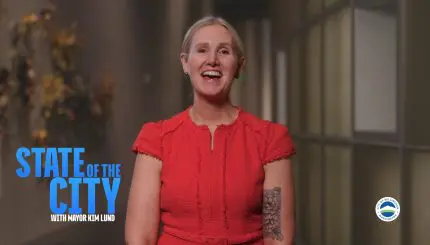 Mayor Kim Lund speaks to the camera. Text on screen says State of the City with Mayor Kim Lund.