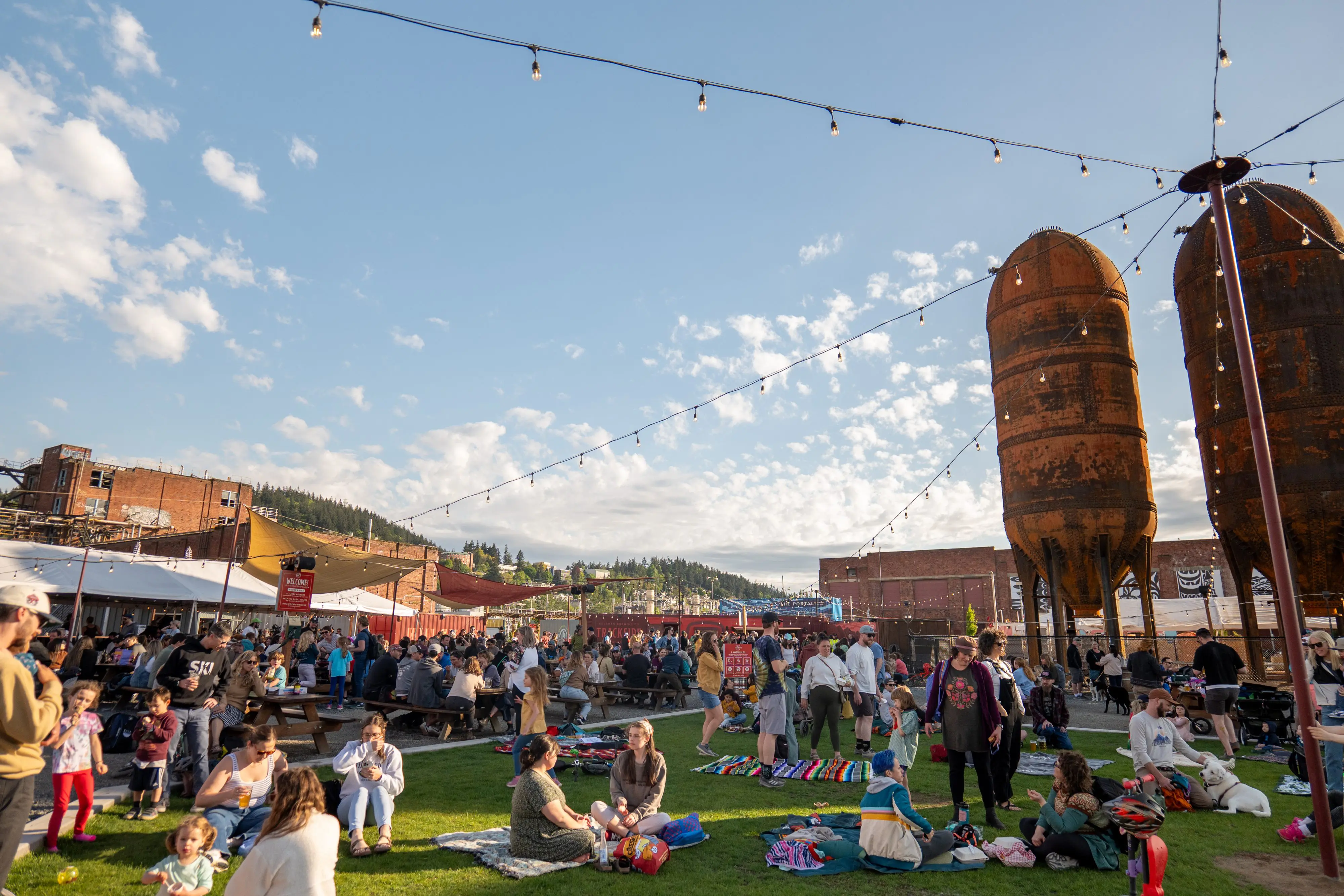 Families play on a beer garden lawn