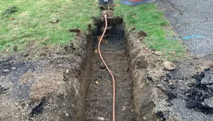Dug out trench with small water pipe inside
