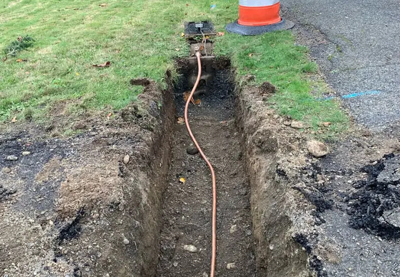 Dug out trench with small water pipe inside