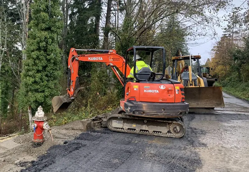 Construction equipment in roadway with fire hydrant nearby