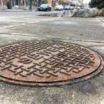 close-up metal sewer cover on Woburn Street