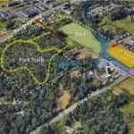 An aerial view of a wooded property with text marking possible future trails