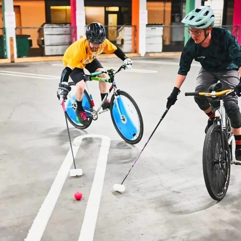 People playing polo on bikes