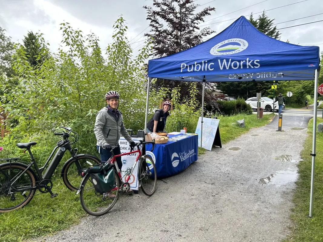 A Bellingham-branded table welcomes bike commuters on a trail