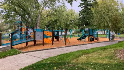 A large blue and orange playset in a park