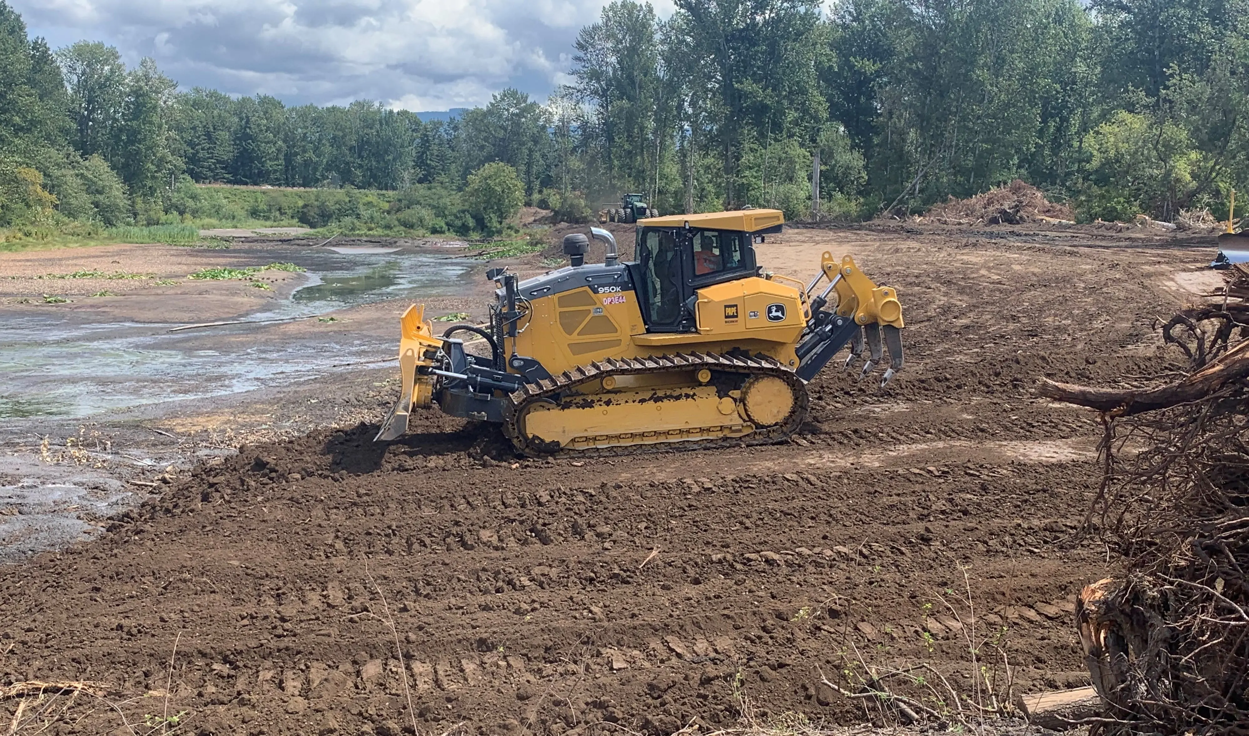 Heavy machinery grading dirt fill