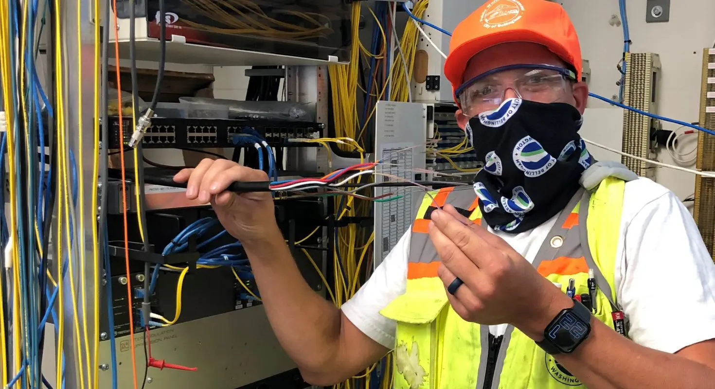 City employee holding up cables