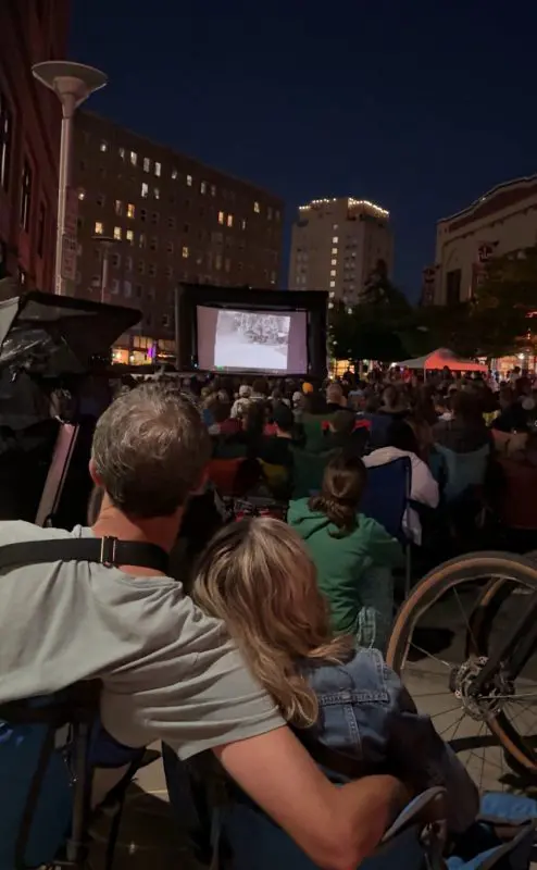Couple watching a movie on the street
