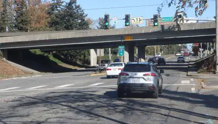 vehicles driving under overpass with Interstate 5 sign