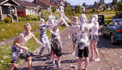 Youth covered in shaving cream on a neighborhood street