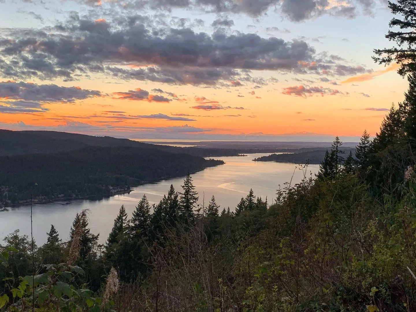 Landscape view of lake with colorful sunset in distance