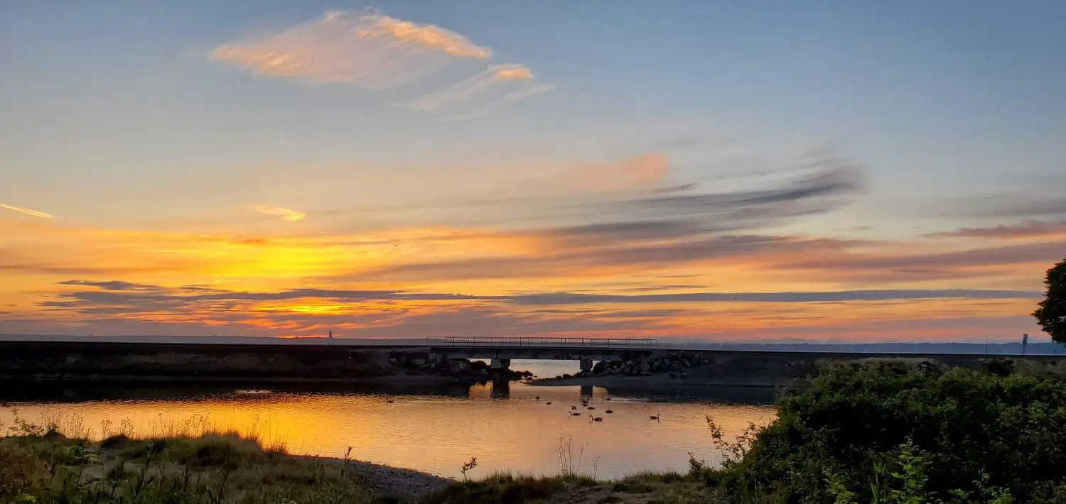 Sunset over the Post Point Lagoon with birds peacefully enjoying the water.