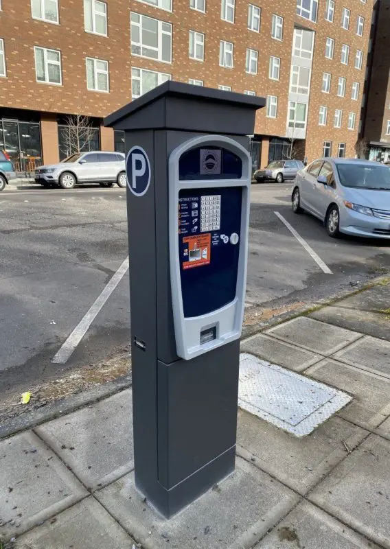 Parking pay station located on a city sidewalk