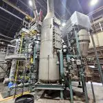 industrial containers and pipe inside a large building