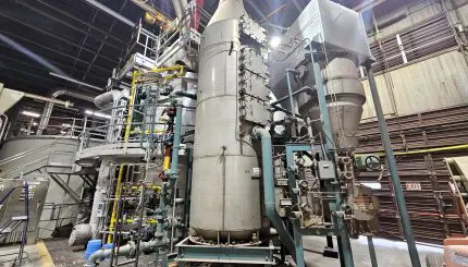 industrial containers and pipe inside a large building