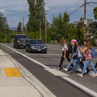 Group of school-aged girls crossing the street at a crosswalk