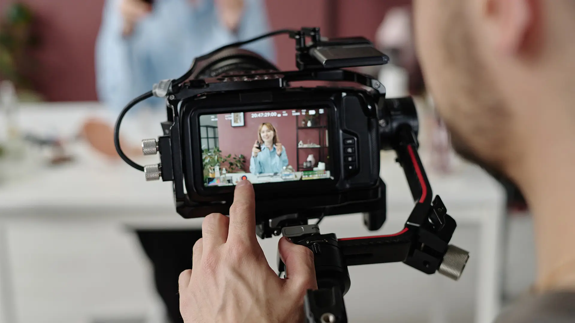 A person touches the screen of a camera.
