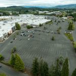 Aerial view of the Bellis Fair Mall showing a mostly empty parking lot during the day.